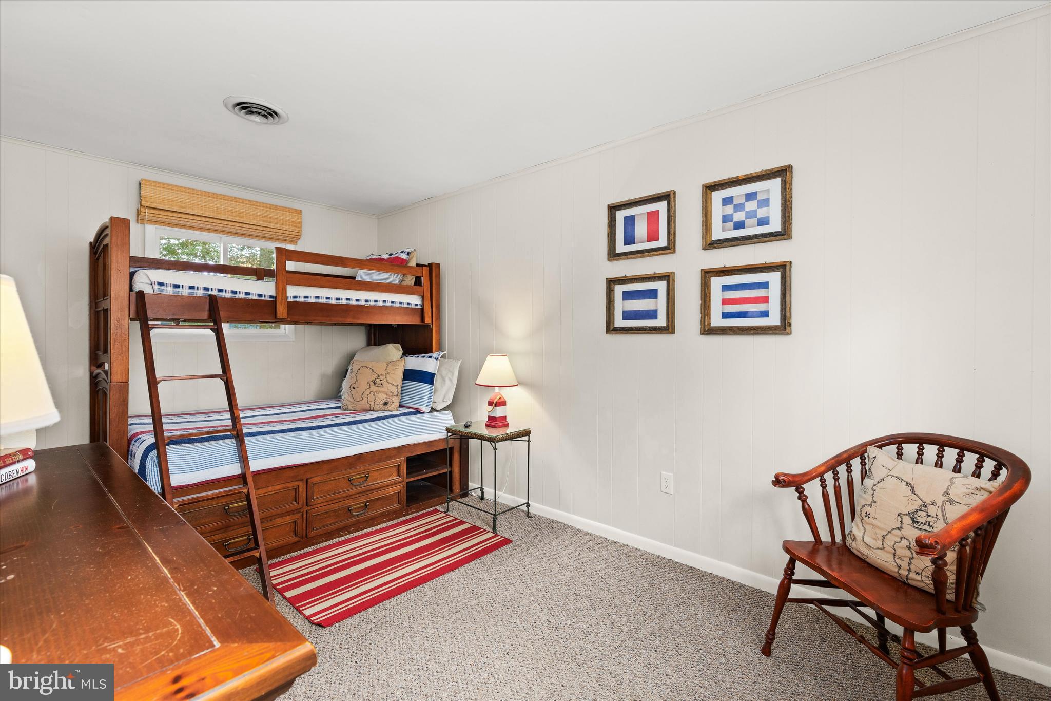 606 Spring Lake Court Bethany Beach, DE 19930 - Photo 34 of 53 a bedroom with furniture and a chair