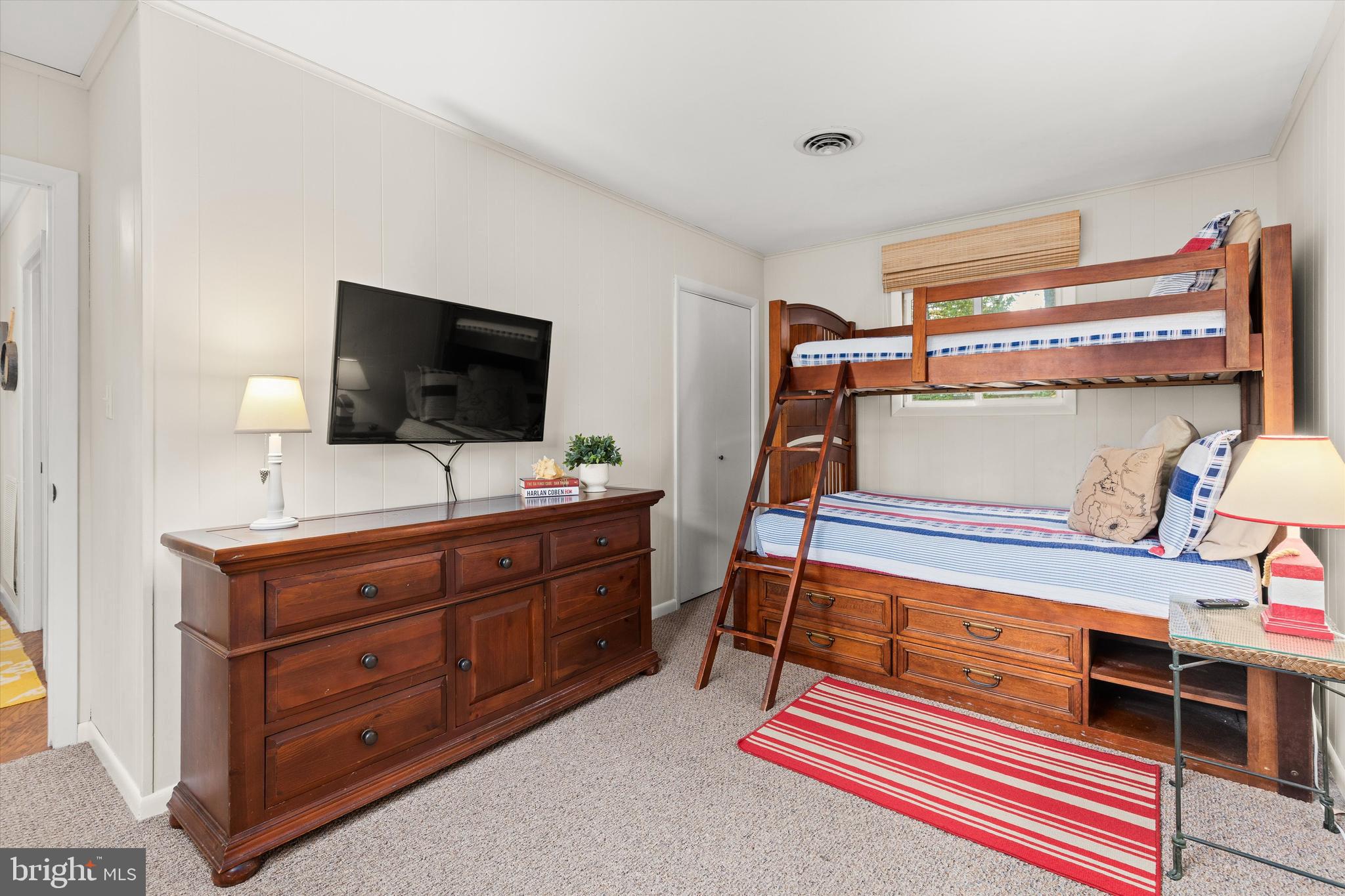 606 Spring Lake Court Bethany Beach, DE 19930 - Photo 35 of 53 a bedroom with a bed and flat screen tv