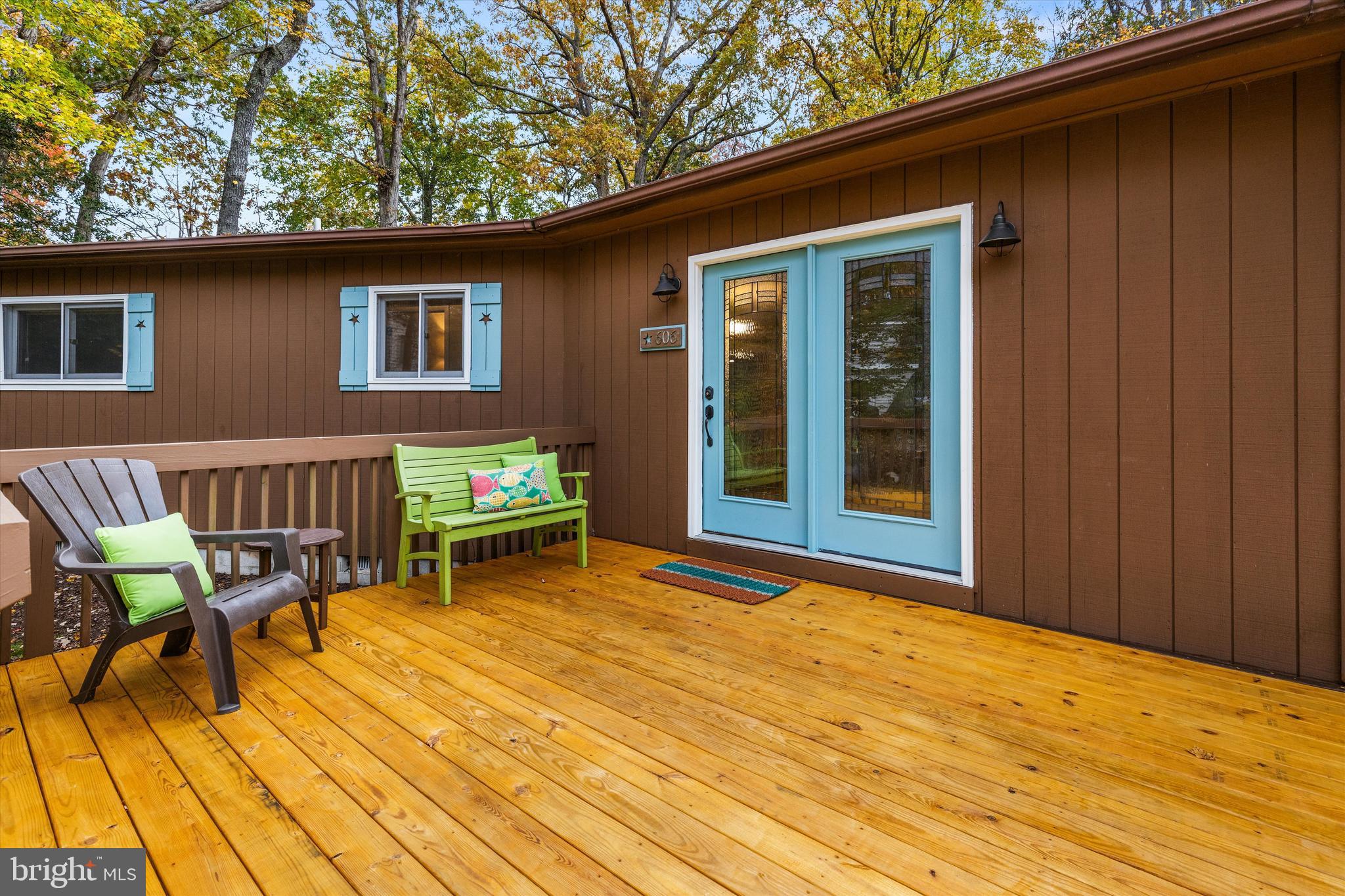 606 Spring Lake Court Bethany Beach, DE 19930 - Photo 37 of 53 a backyard of a house with barbeque oven table and chairs