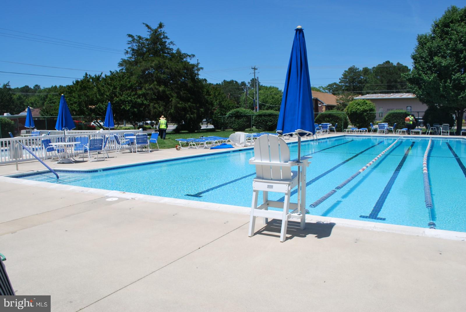 606 Spring Lake Court Bethany Beach, DE 19930 - Photo 47 of 53 a view of a swimming pool with a patio and a yard
