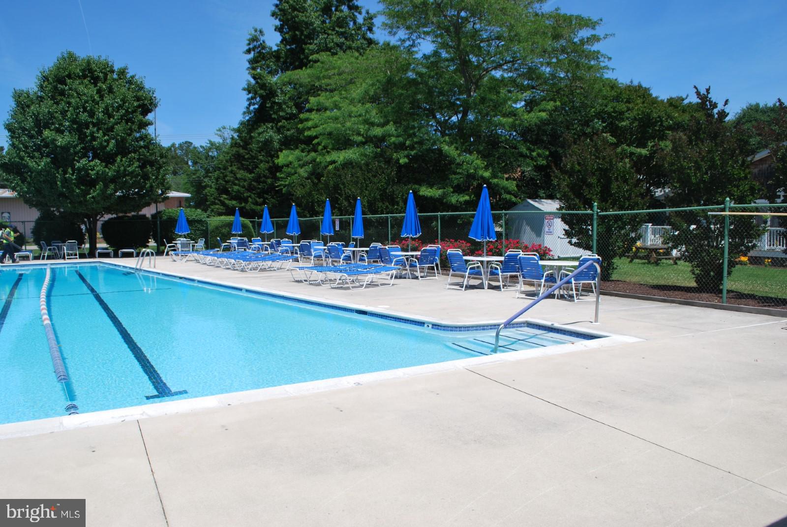 606 Spring Lake Court Bethany Beach, DE 19930 - Photo 48 of 53 a view of a dinning tables and chairs in the patio