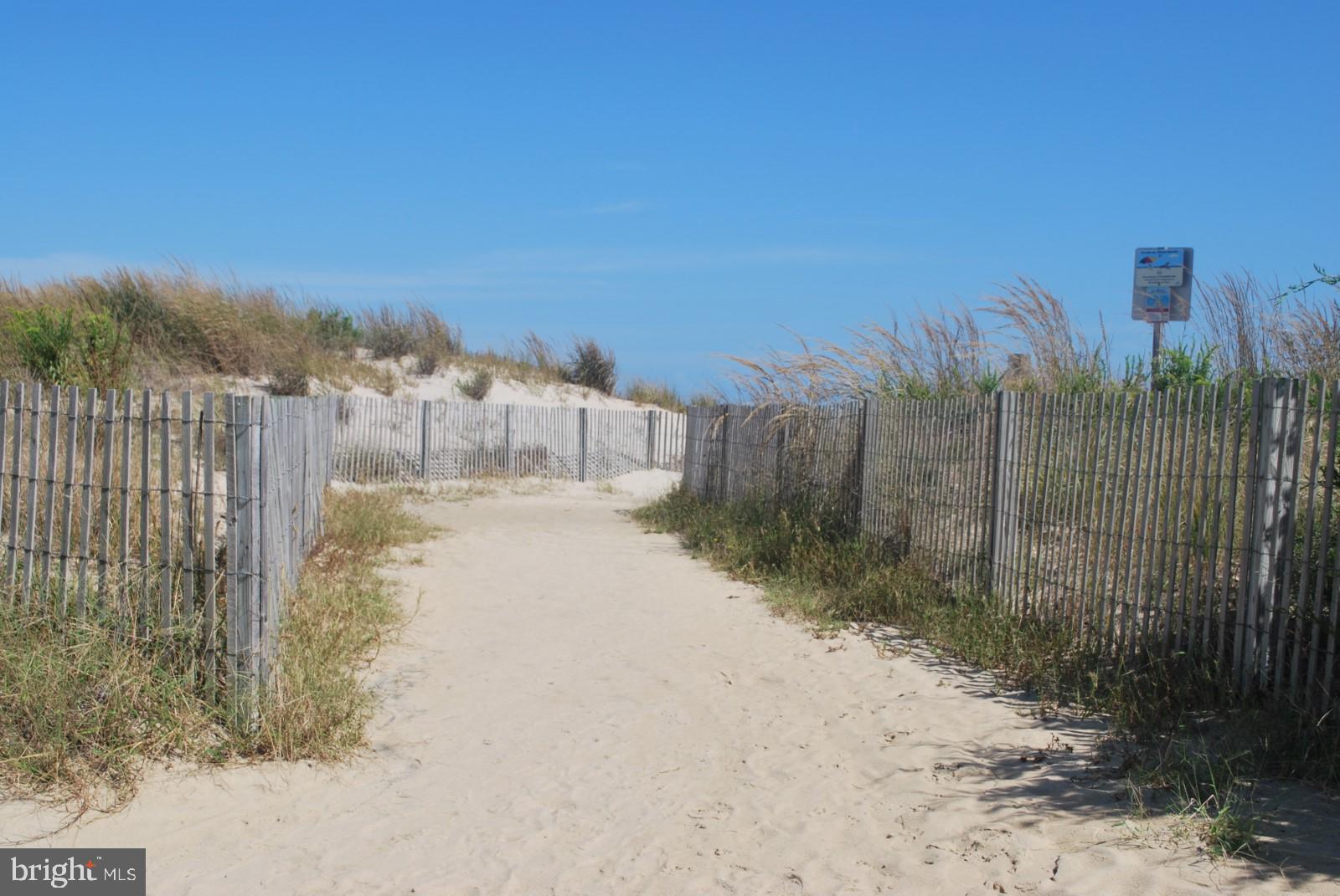 606 Spring Lake Court Bethany Beach, DE 19930 - Photo 53 of 53 a view of a pathway with a wrought fence