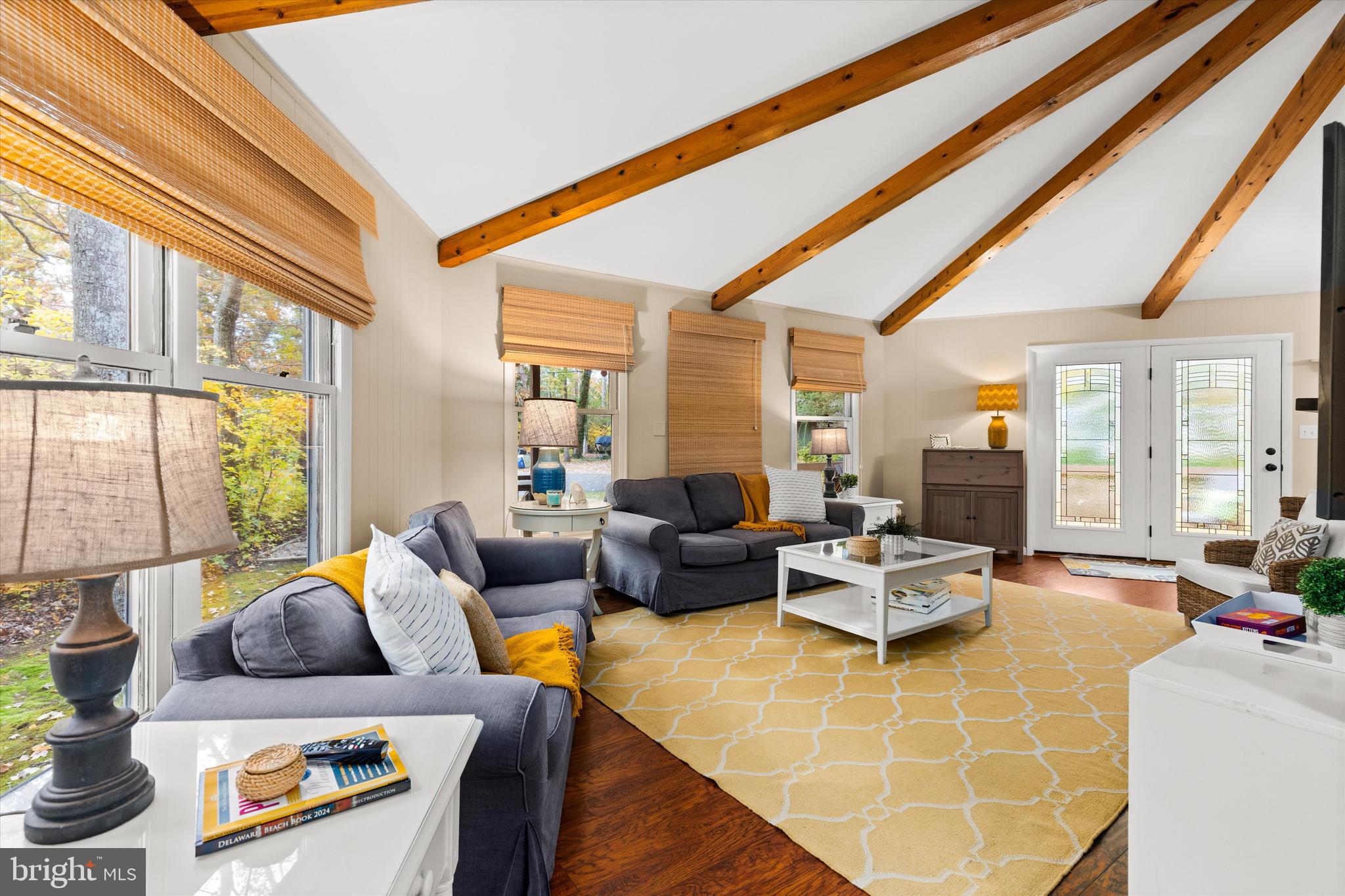 606 Spring Lake Court Bethany Beach, DE 19930 - Photo 6 of 53 a living room with furniture and a large window