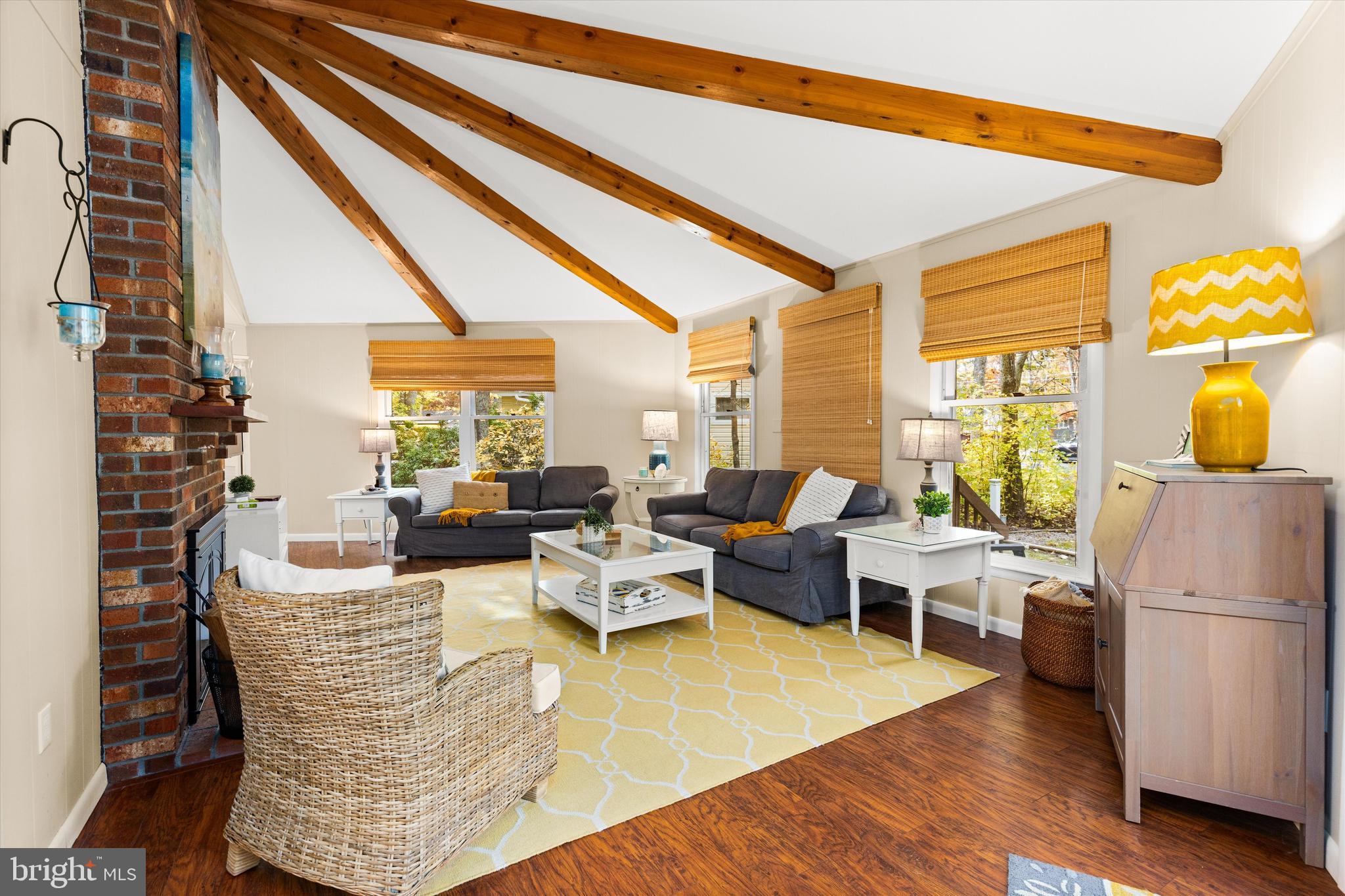 606 Spring Lake Court Bethany Beach, DE 19930 - Photo 7 of 53 a living room with fireplace furniture and a large window