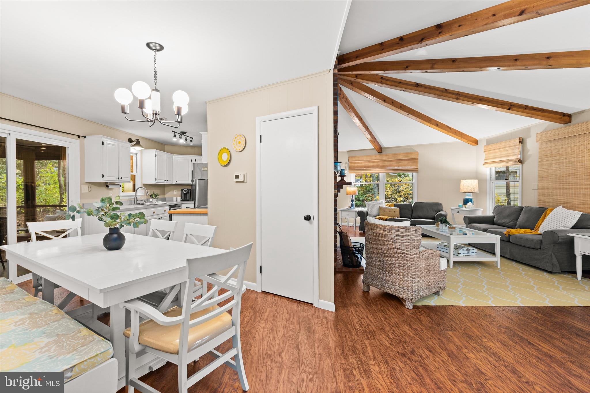 606 Spring Lake Court Bethany Beach, DE 19930 - Photo 9 of 53 a view of a dining room with furniture window and wooden floor