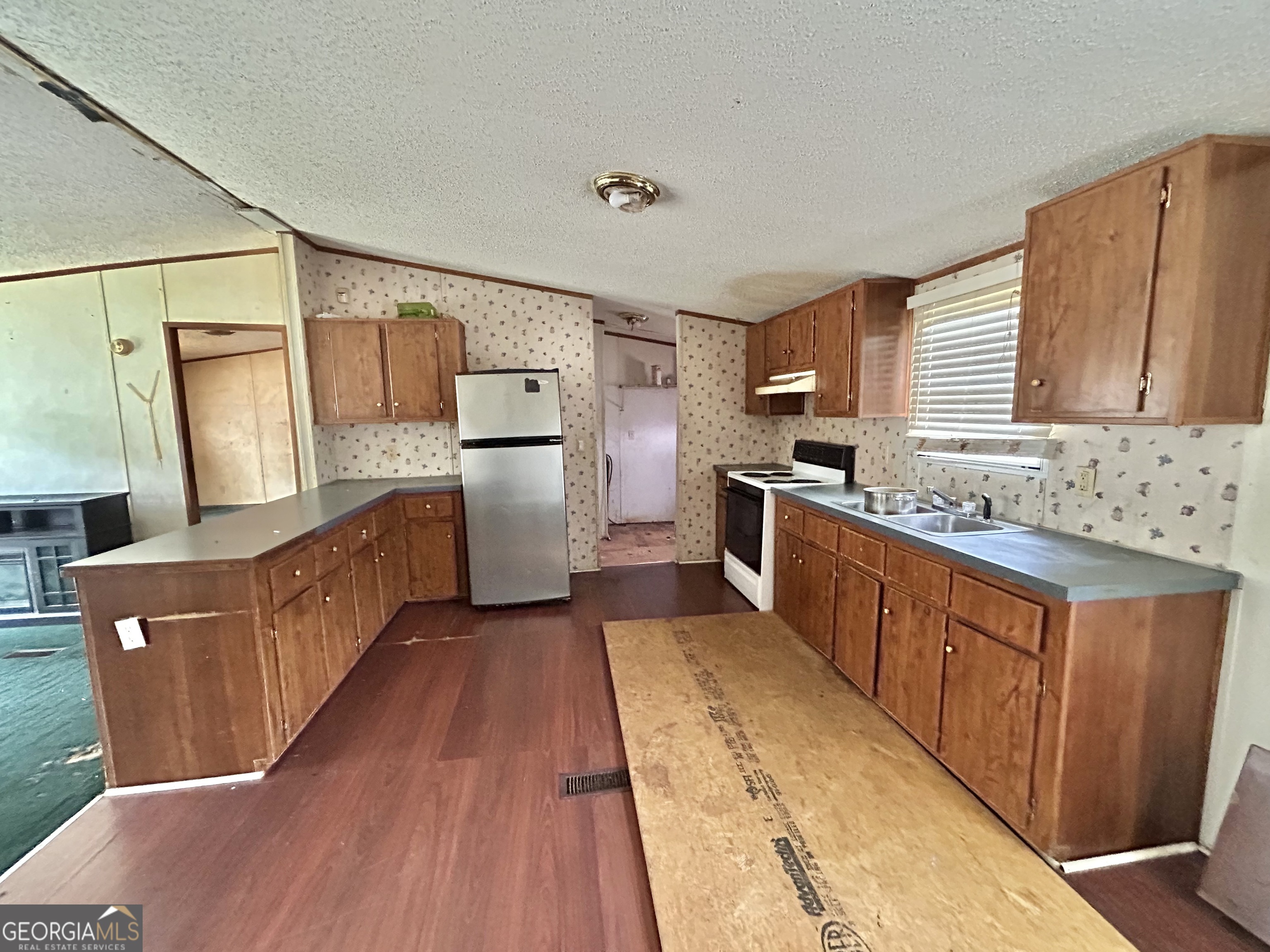 1299 Bodie Rayle Road Elberton, GA 30635 - Photo 3 of 18 a kitchen with stainless steel appliances granite countertop a refrigerator a stove top oven a sink and dishwasher