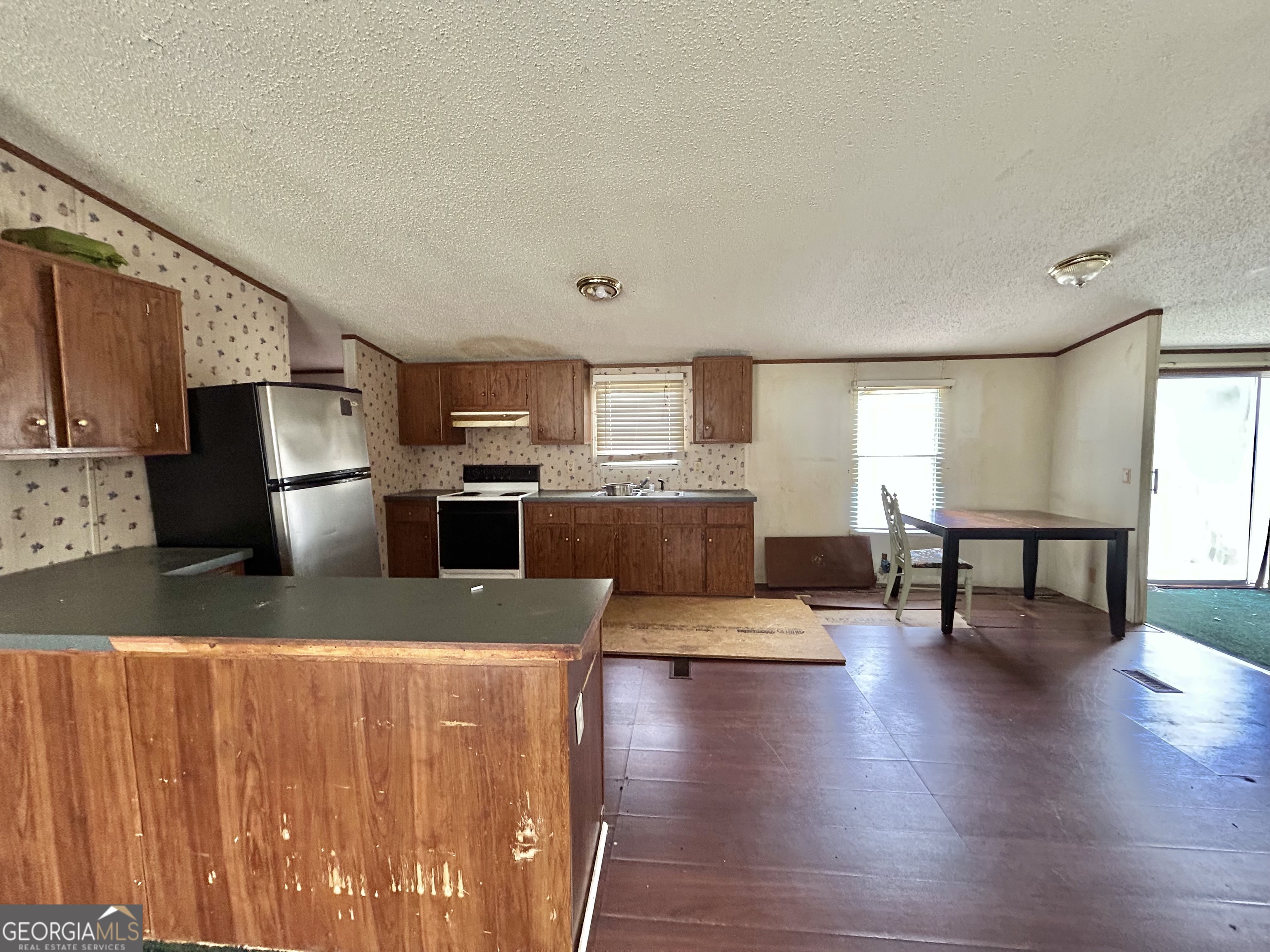 1299 Bodie Rayle Road Elberton, GA 30635 - Photo 4 of 18 a kitchen with stainless steel appliances granite countertop a refrigerator a stove top oven a sink with granite countertops and cabinets