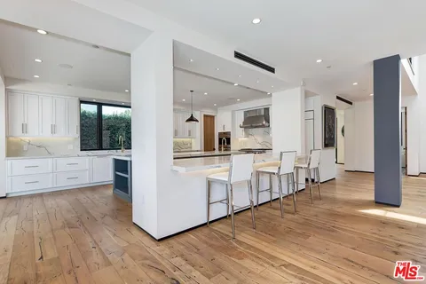 an open kitchen with dining table and chairs