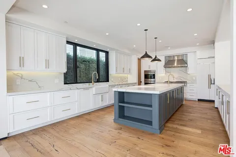 a kitchen with granite countertop a stove and a refrigerator