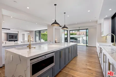 a view of an empty room with glass door and a window