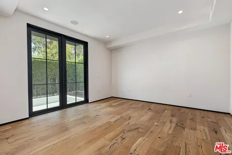 a view of an empty room with glass door
