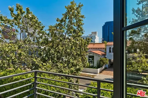 a bathroom with a toilet sink vanity and mirror