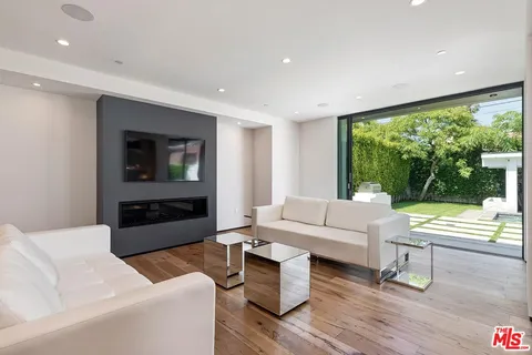 a living room with fireplace furniture and a flat screen tv