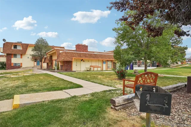 a front view of a house with a yard table and chairs