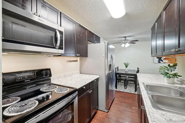 a kitchen with granite countertop stainless steel appliances and wooden cabinets