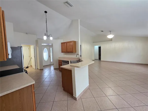 a large kitchen with cabinets a sink and a stove