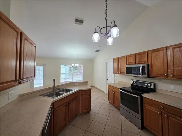 a kitchen with stainless steel appliances granite countertop a sink and stove top oven