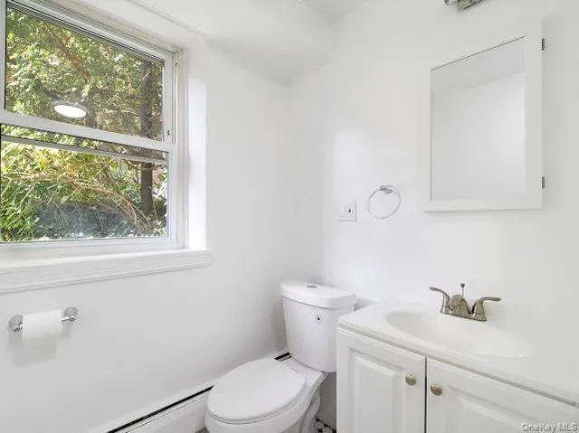 a white toilet sitting next to a bathroom sink