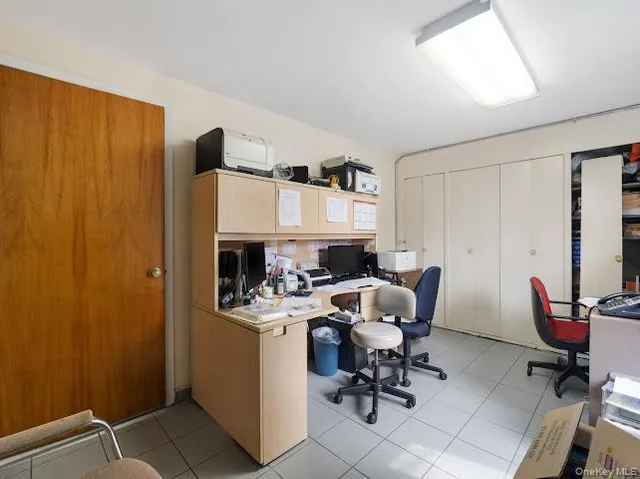 a view of a workspace with furniture and a chair