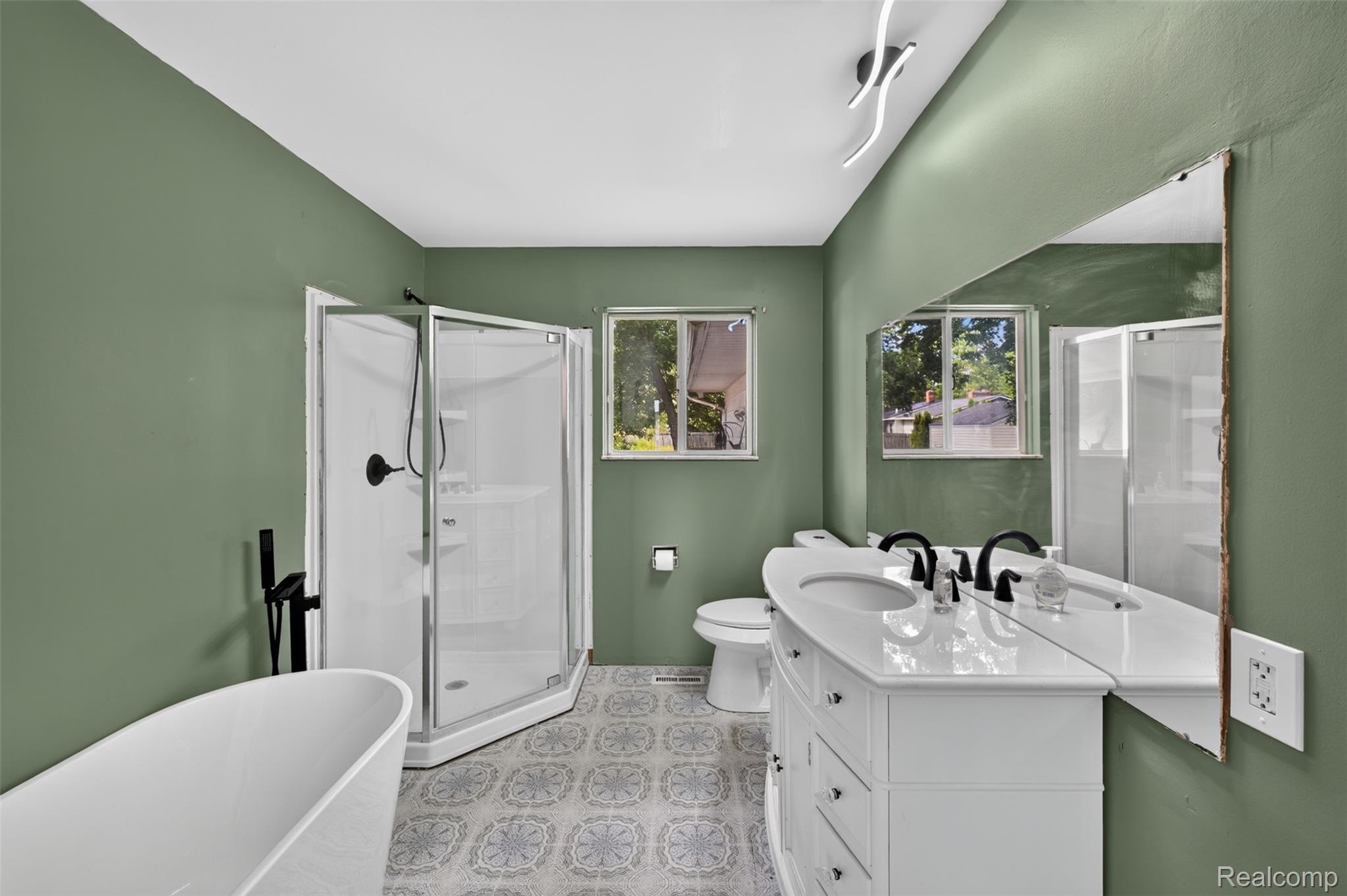 5457 Reid Road Swartz Creek, MI 48473 - Photo 23 of 51 Bathroom with green walls and patterned flooring