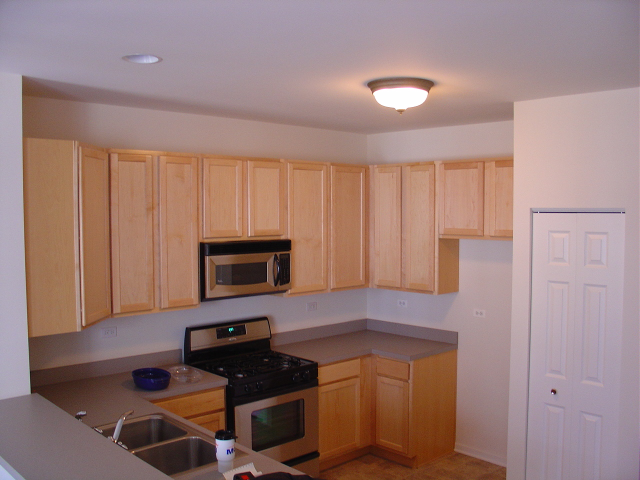 229 Springbrook Trail South Oswego, IL 60543 - Photo 3 of 10 a kitchen with a refrigerator and a stove top oven