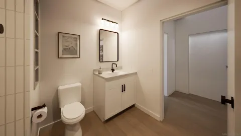 a spacious bathroom with a toilet sink and mirror