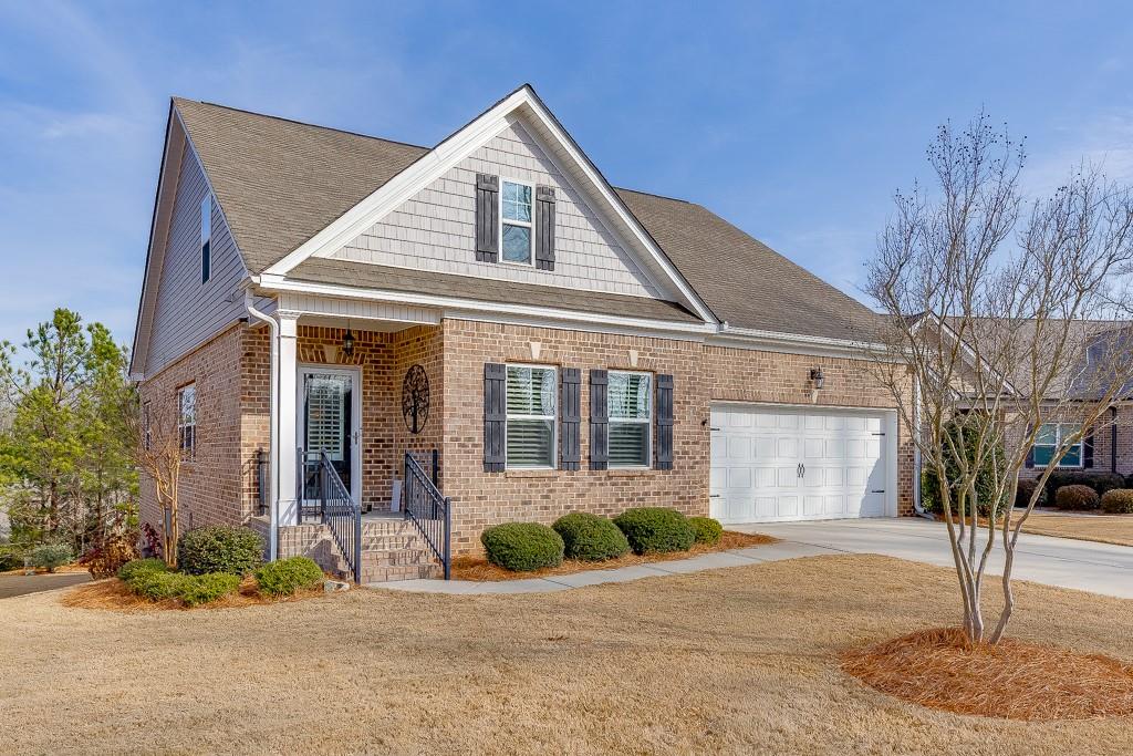567 Lillian Way Jefferson, GA 30549 - Photo 2 of 80 a front view of a house with a garden