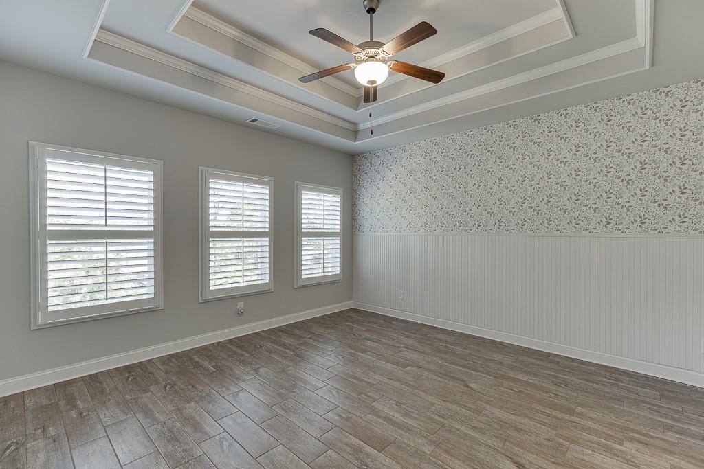 567 Lillian Way Jefferson, GA 30549 - Photo 25 of 80 a view of an empty room with a window and a chandelier fan