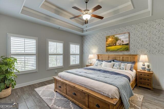 567 Lillian Way Jefferson, GA 30549 - Photo 29 of 80 a bedroom with a bed and a chandelier
