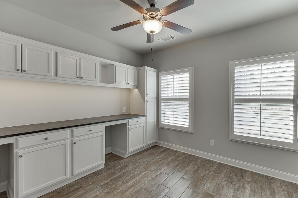 567 Lillian Way Jefferson, GA 30549 - Photo 33 of 80 a kitchen with white cabinets and window