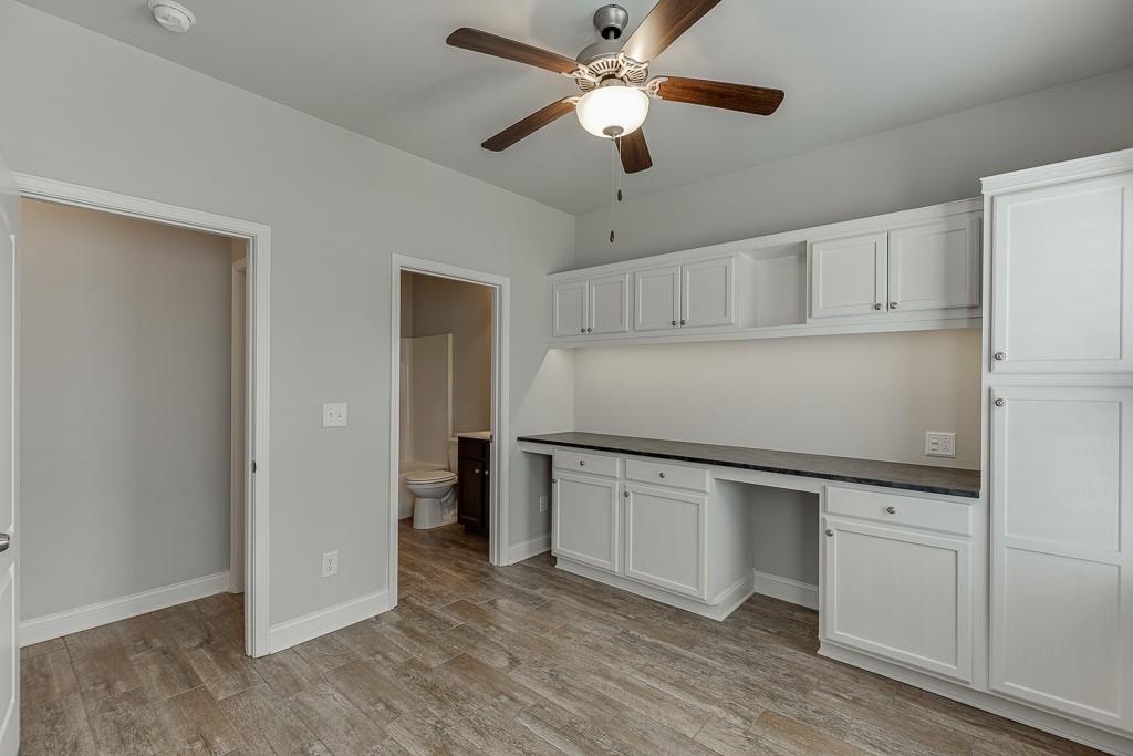 567 Lillian Way Jefferson, GA 30549 - Photo 35 of 80 a kitchen with granite countertop a refrigerator a sink and white cabinets
