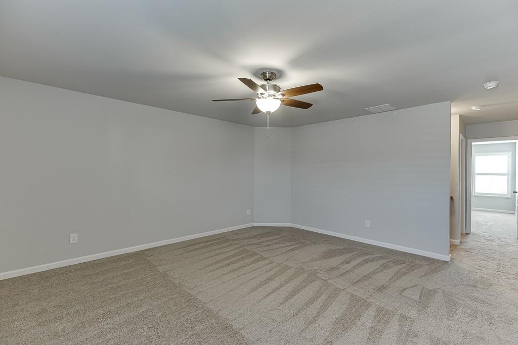 567 Lillian Way Jefferson, GA 30549 - Photo 39 of 80 a view of a room with a ceiling fan and window