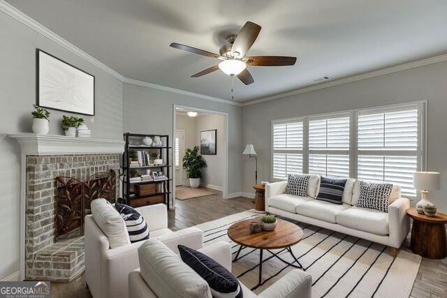 567 Lillian Way Jefferson, GA 30549 - Photo 7 of 80 a living room with furniture a fireplace and a large window