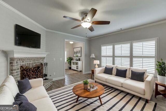 567 Lillian Way Jefferson, GA 30549 - Photo 8 of 80 a living room with furniture a fireplace and a flat screen tv