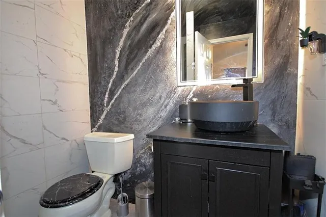 a spacious bedroom with a bed and a chandelier