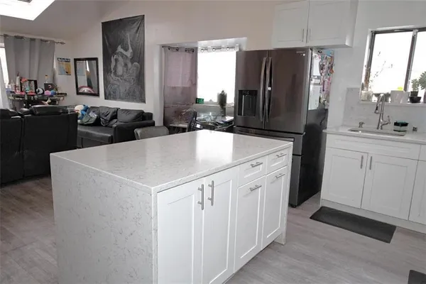 a kitchen with a sink a stove a refrigerator and a refrigerator