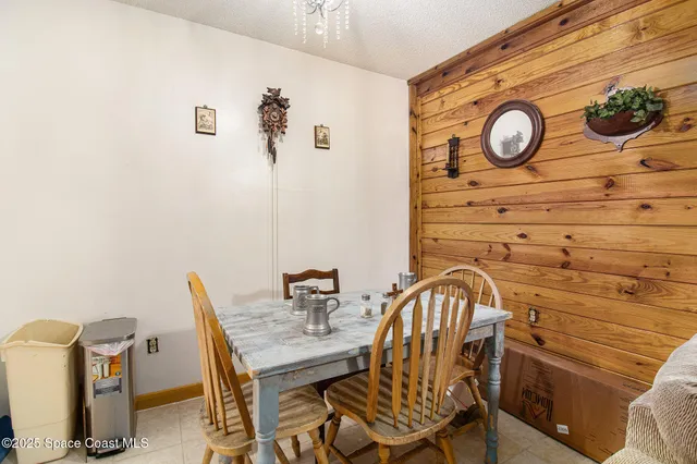 a view of a dining area with furniture and wall clock
