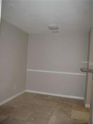 a bathroom with a granite countertop sink a toilet and a mirror