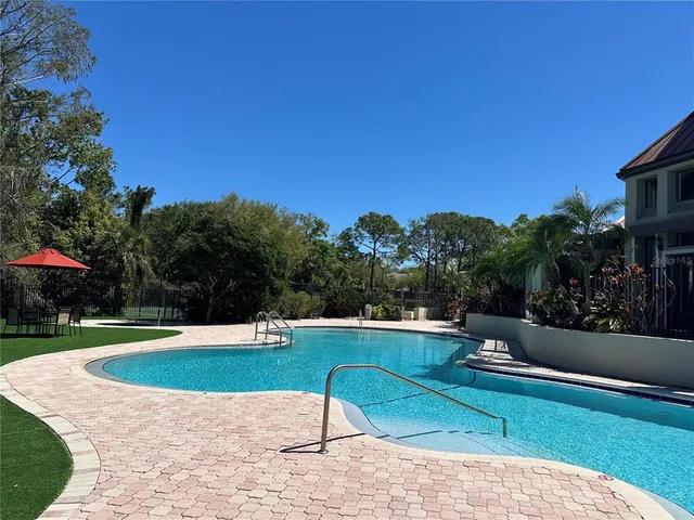 a view of a house with swimming pool and porch