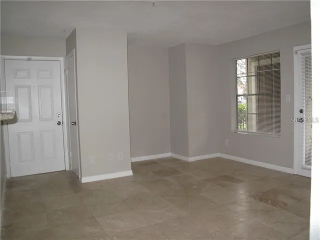 a view of an empty room with windows