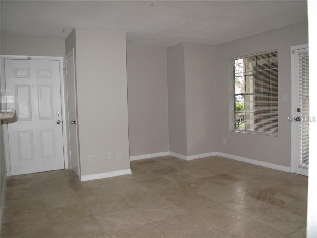 216 Afton Square, Unit 111 Altamonte Springs, FL 32714 - Photo 4 of 41 a view of an empty room with windows
