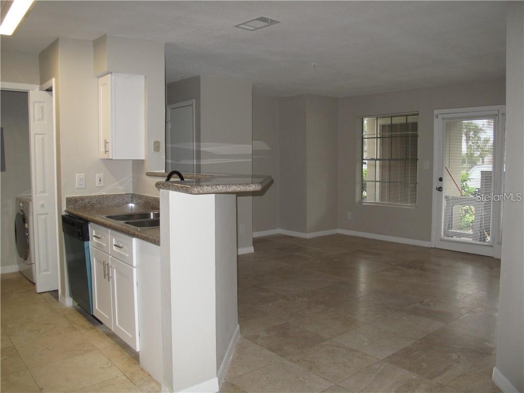 216 Afton Square, Unit 111 Altamonte Springs, FL 32714 - Photo 5 of 41 a kitchen with stainless steel appliances granite countertop a sink stove and cabinets