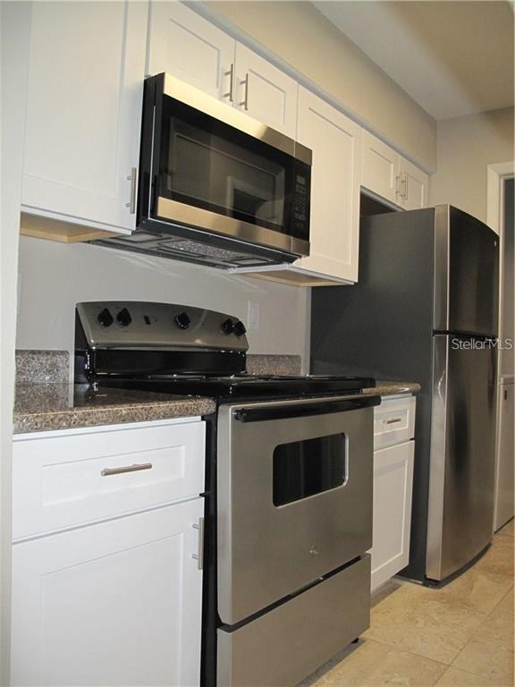 216 Afton Square, Unit 111 Altamonte Springs, FL 32714 - Photo 8 of 41 a kitchen with a refrigerator stove and microwave