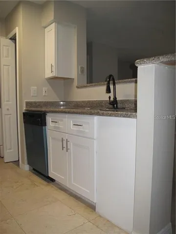 a kitchen with a sink and cabinets