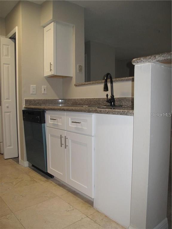 216 Afton Square, Unit 111 Altamonte Springs, FL 32714 - Photo 10 of 41 a kitchen with a sink and cabinets