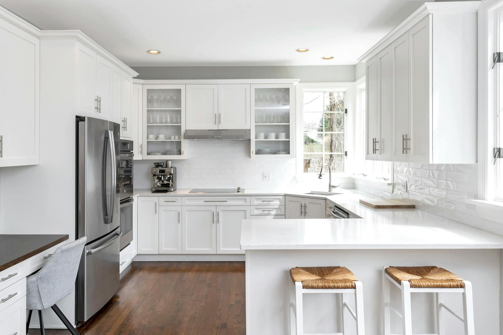 16 Meadowbrook Road Darien, CT 06820 - Photo 7 of 20 a kitchen with a sink a refrigerator and cabinets