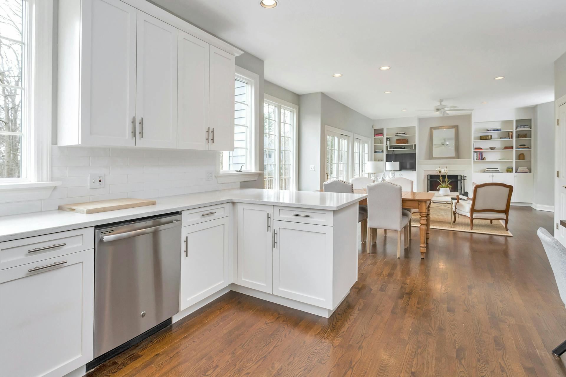 16 Meadowbrook Road Darien, CT 06820 - Photo 8 of 20 a kitchen with white cabinets and chairs