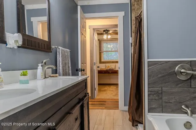 a bedroom with a bed and a dresser with mirror