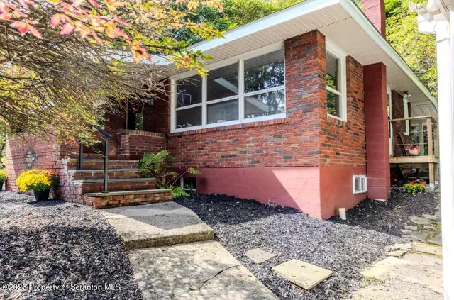 a brick building with a door and a window