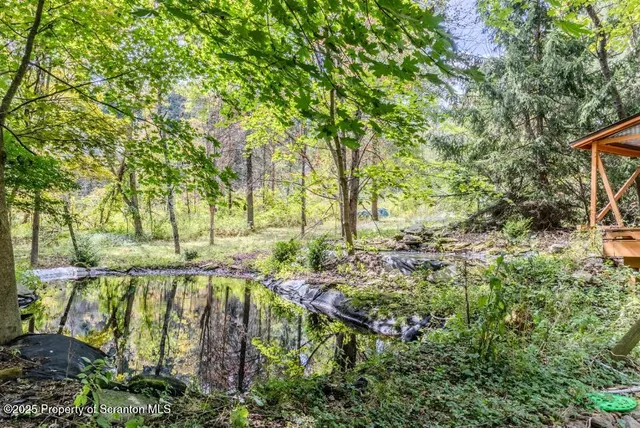 an aerial view of a house with a yard table and chairs